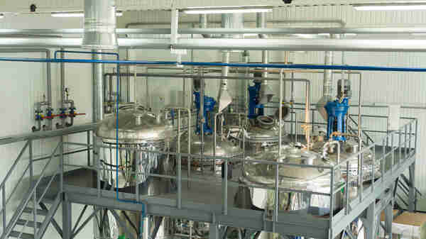 Large storage vats inside a speciality chemicals production plant