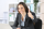 Female building services consultant working on laptop with thumbs up