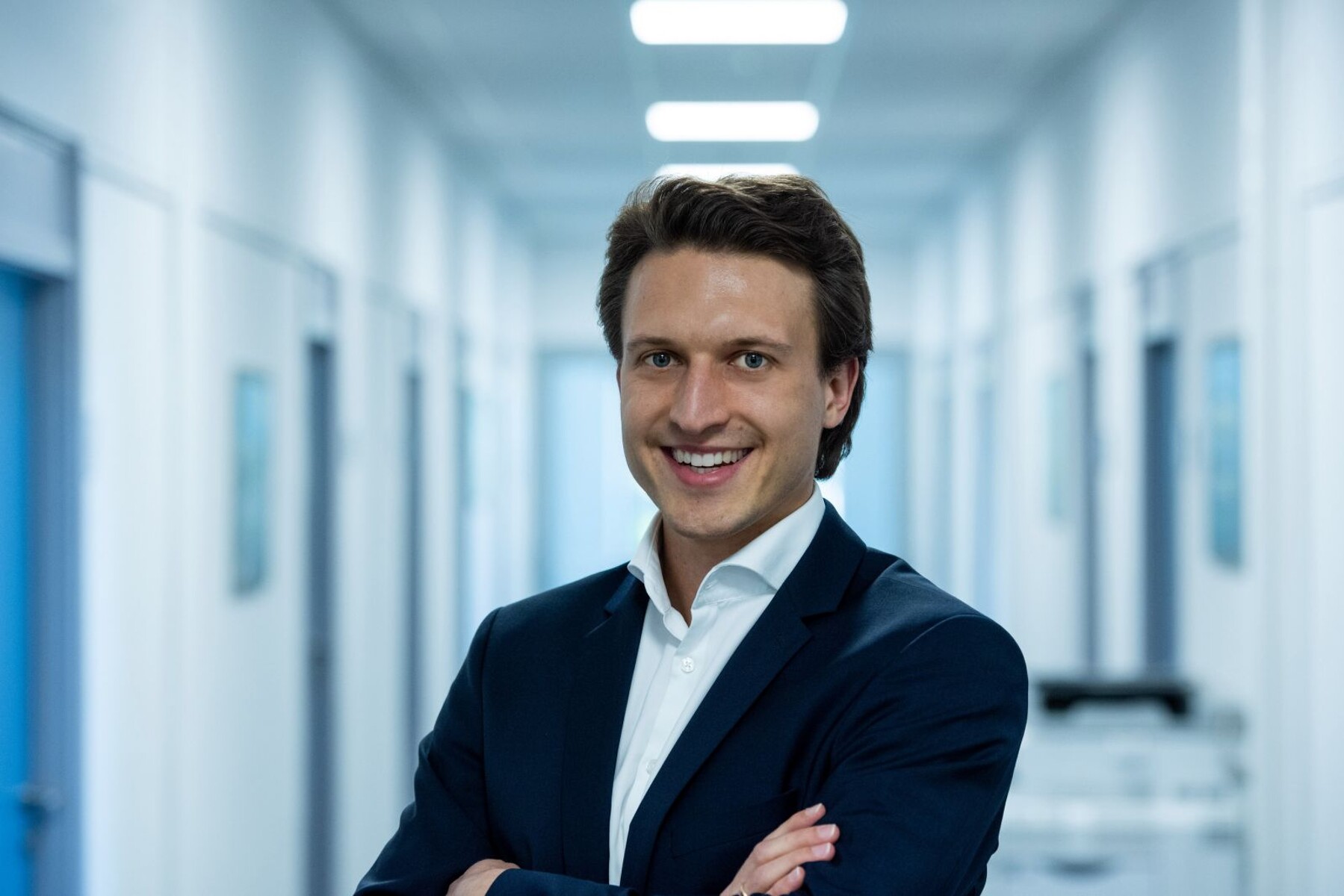 Xaver Hauser, Global Happiness Manager at KSB, smiling in an office corridor