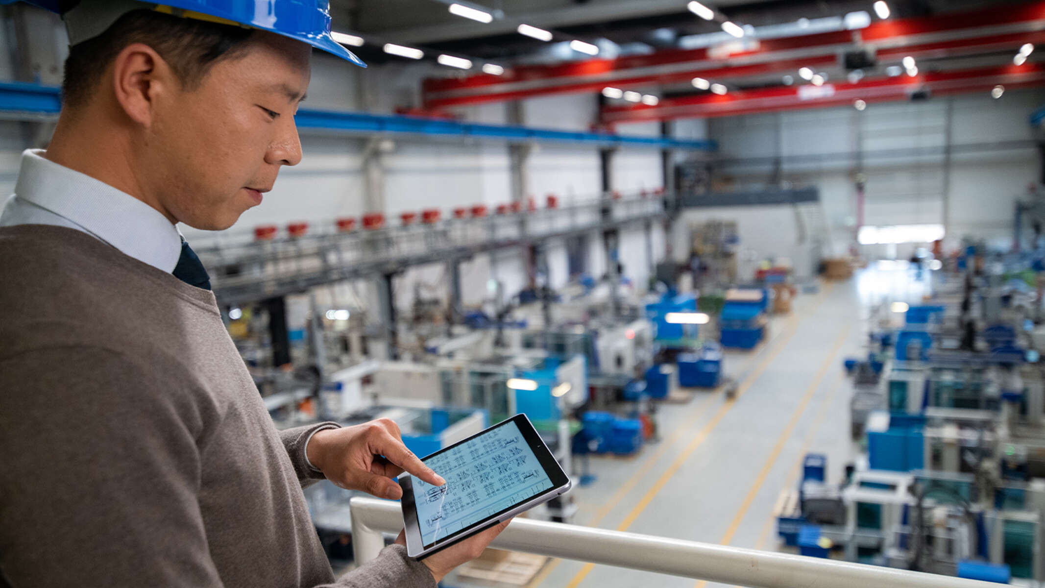 Service engineer checking digital pump control system in a plant.