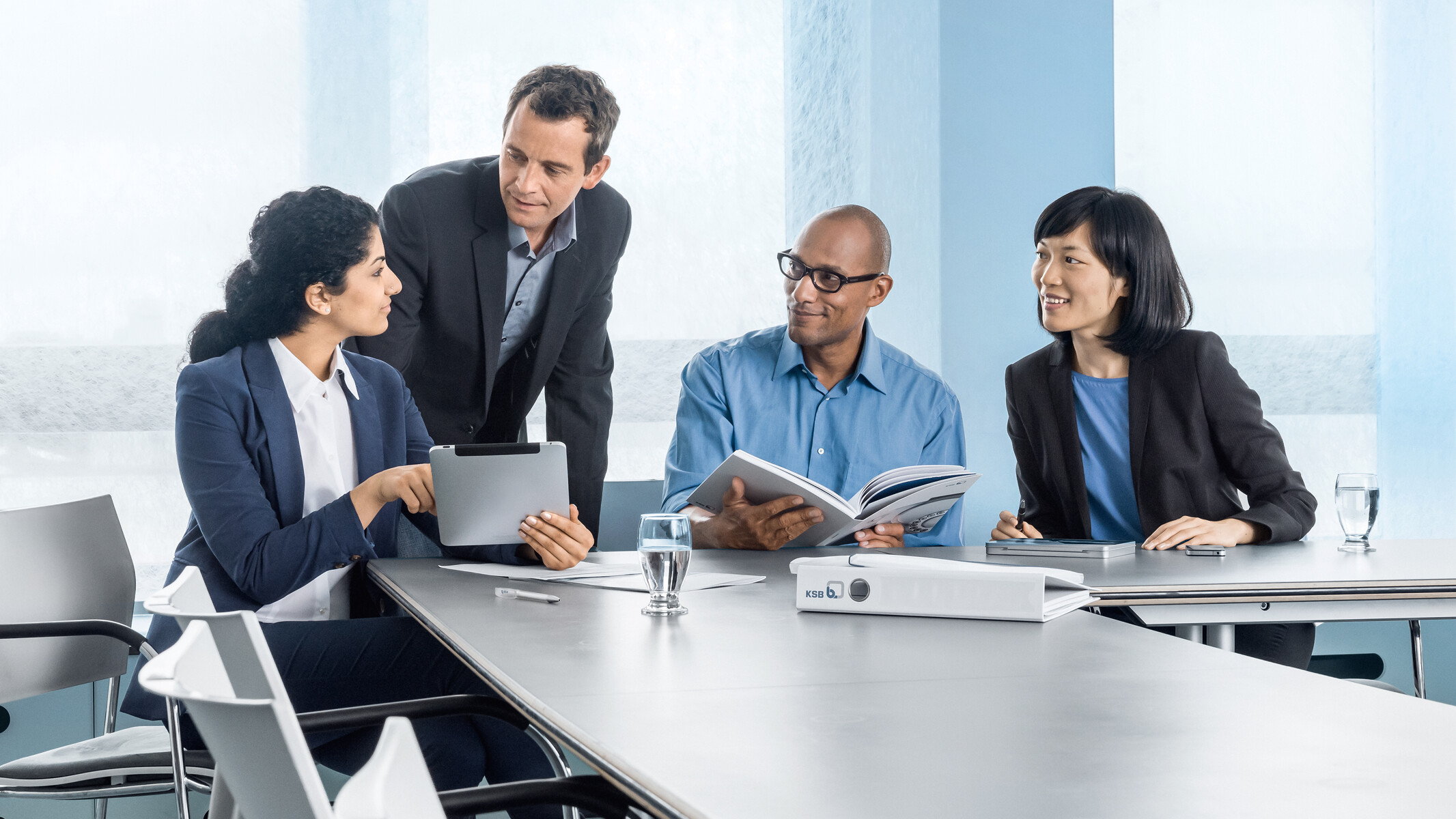 Four colleagues having a discussion in the office