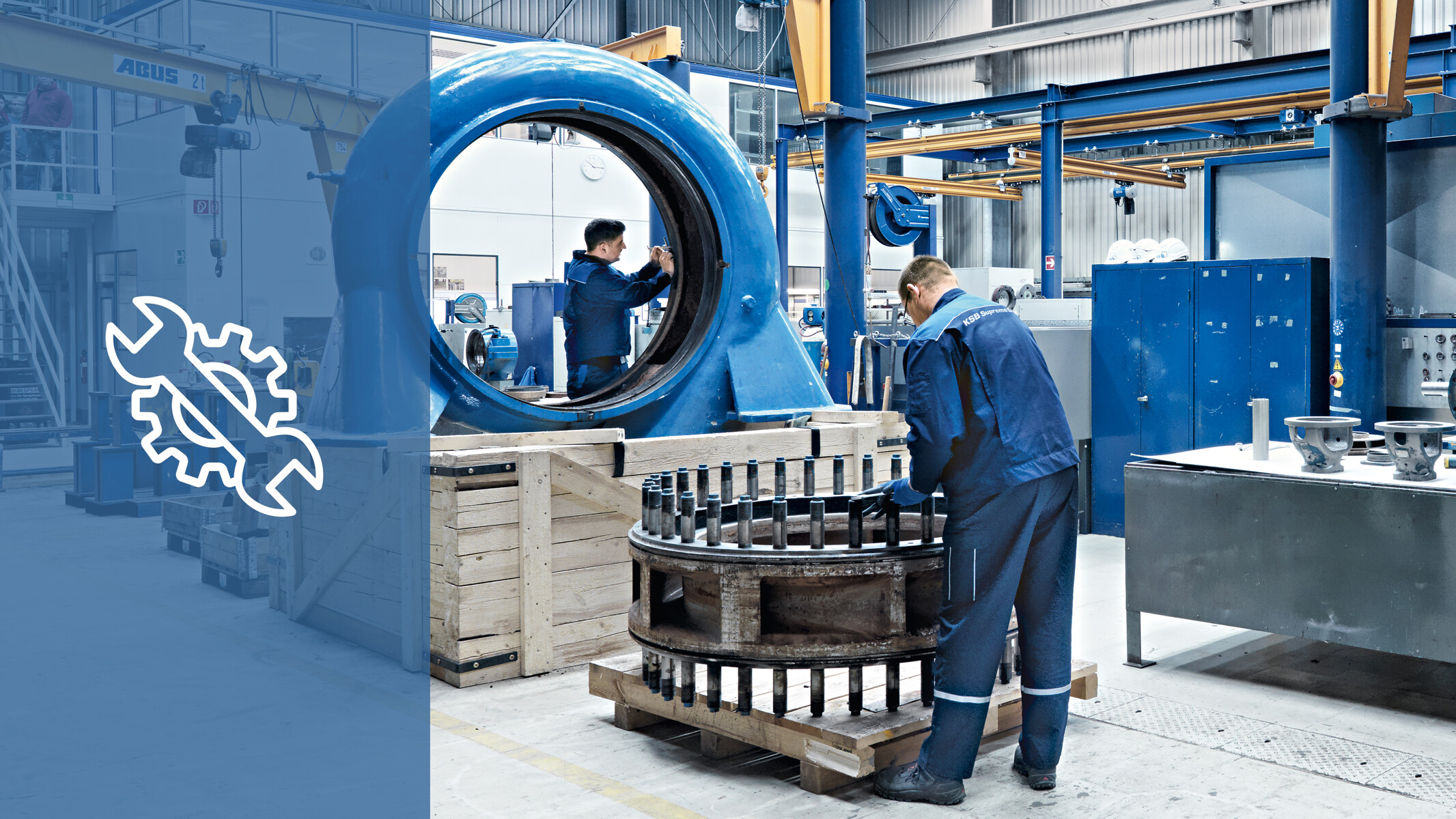 Two KSB service employees working on and repairing parts of a pump in a KSB service centre