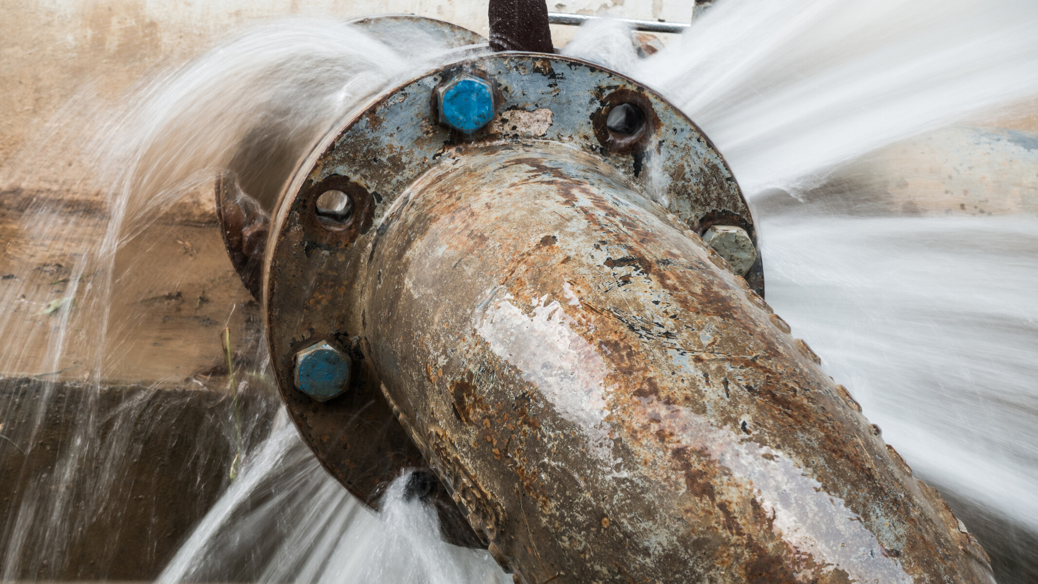 High-pressure water escaping from a leaking pipe