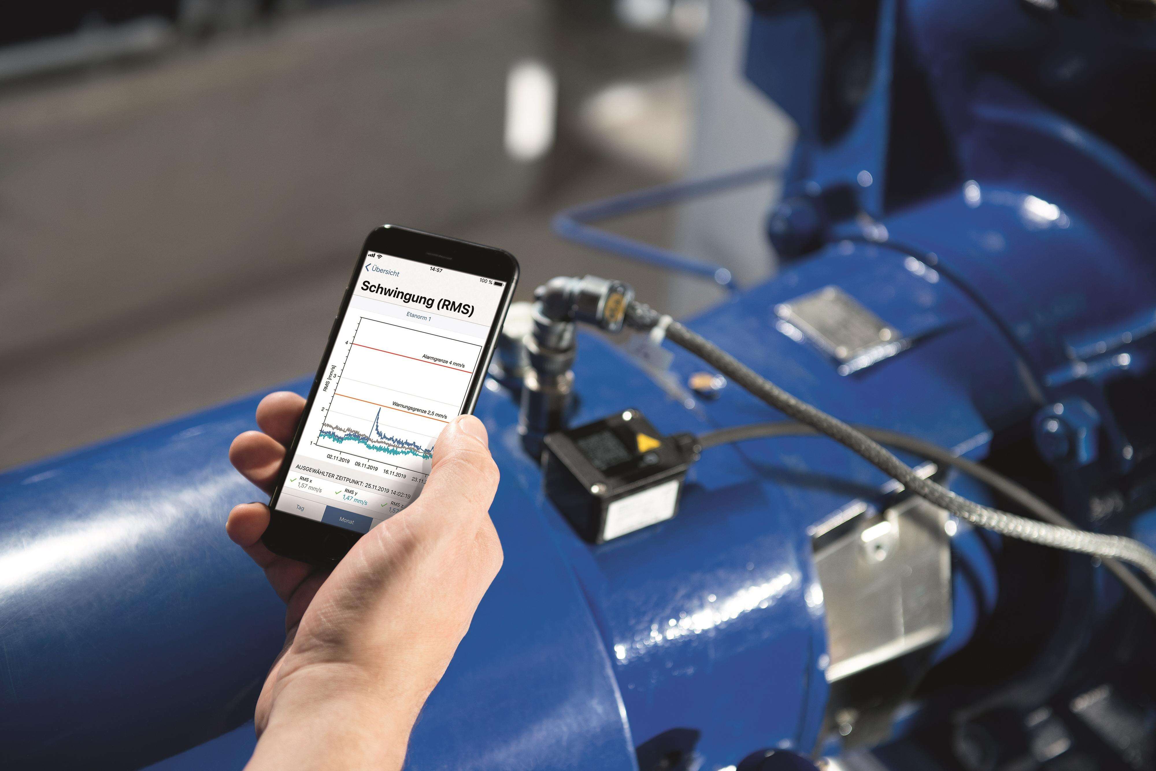 <p>Hand holding a mobile phone with a graph displayed on the screen. In the background is a KSB pump with installed KSB Guard.</p> Hand holding a mobile phone with a graph displayed on the screen. In the background is a KSB pump with installed KSB Guard.
