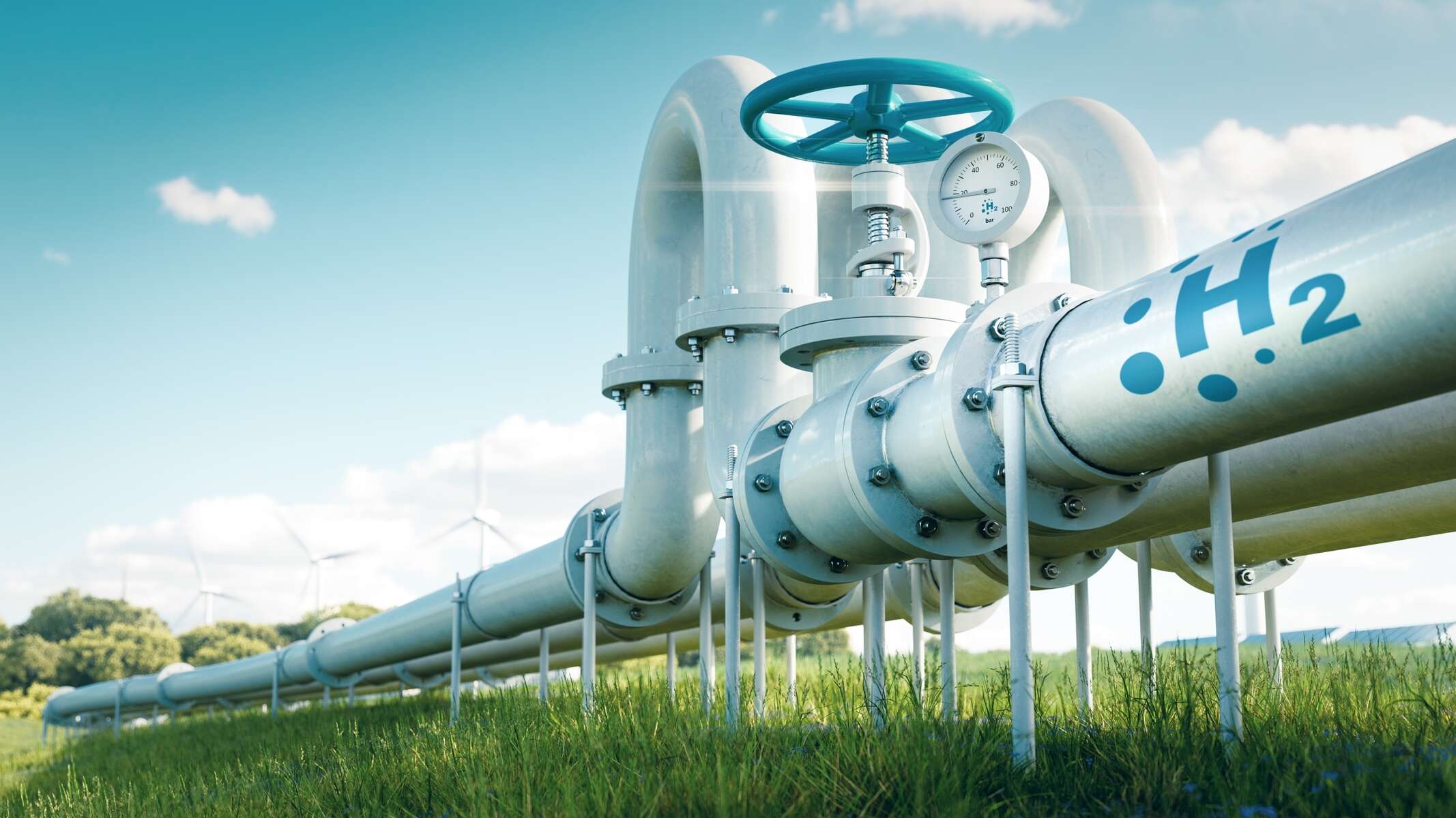 A hydrogen pipeline with wind turbines in the background.