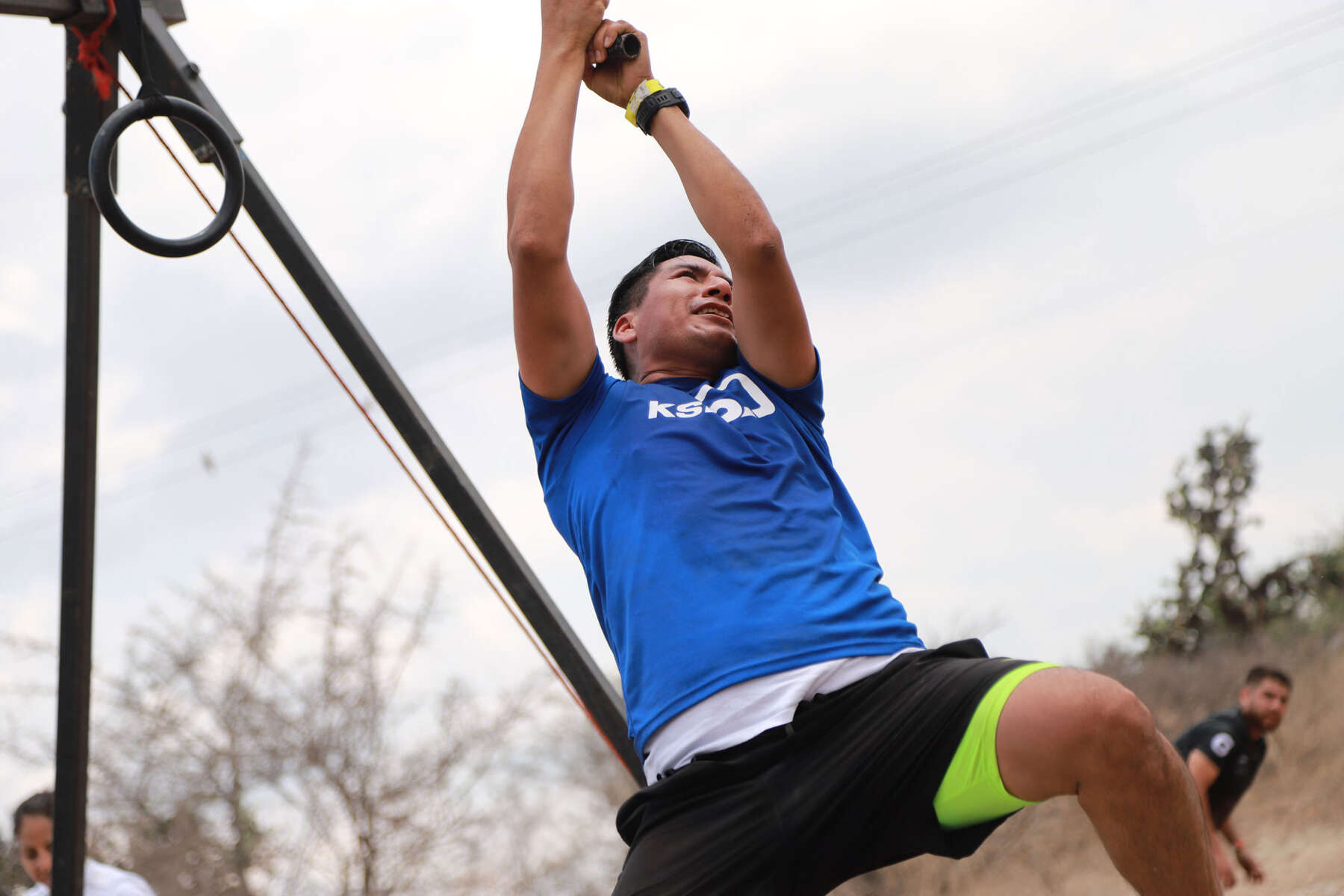 A KSB employee swings over an obstacle on a rope during the Burden Run.