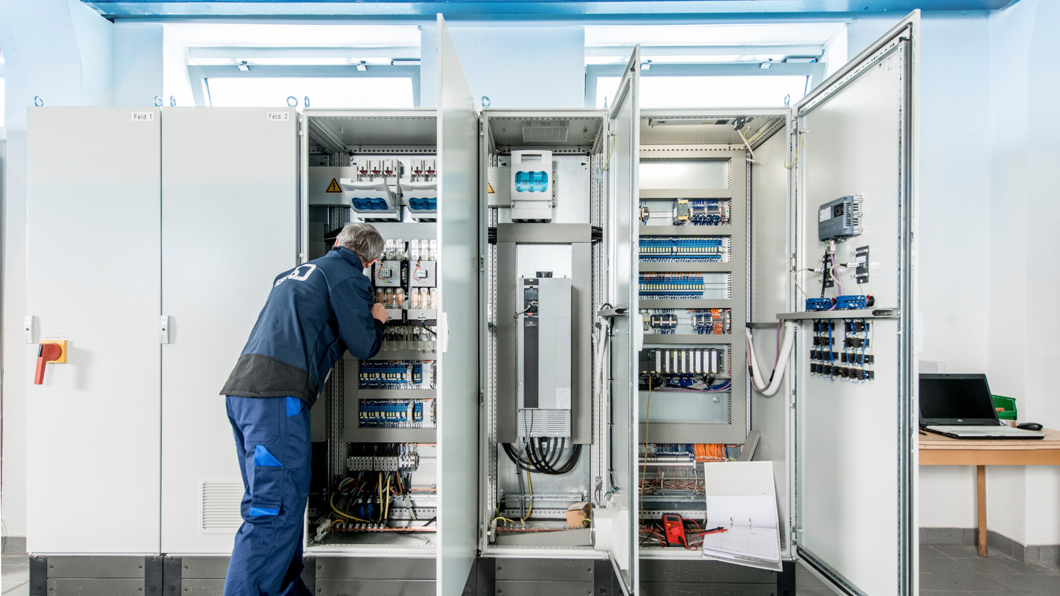 Installer working on a control cabinet