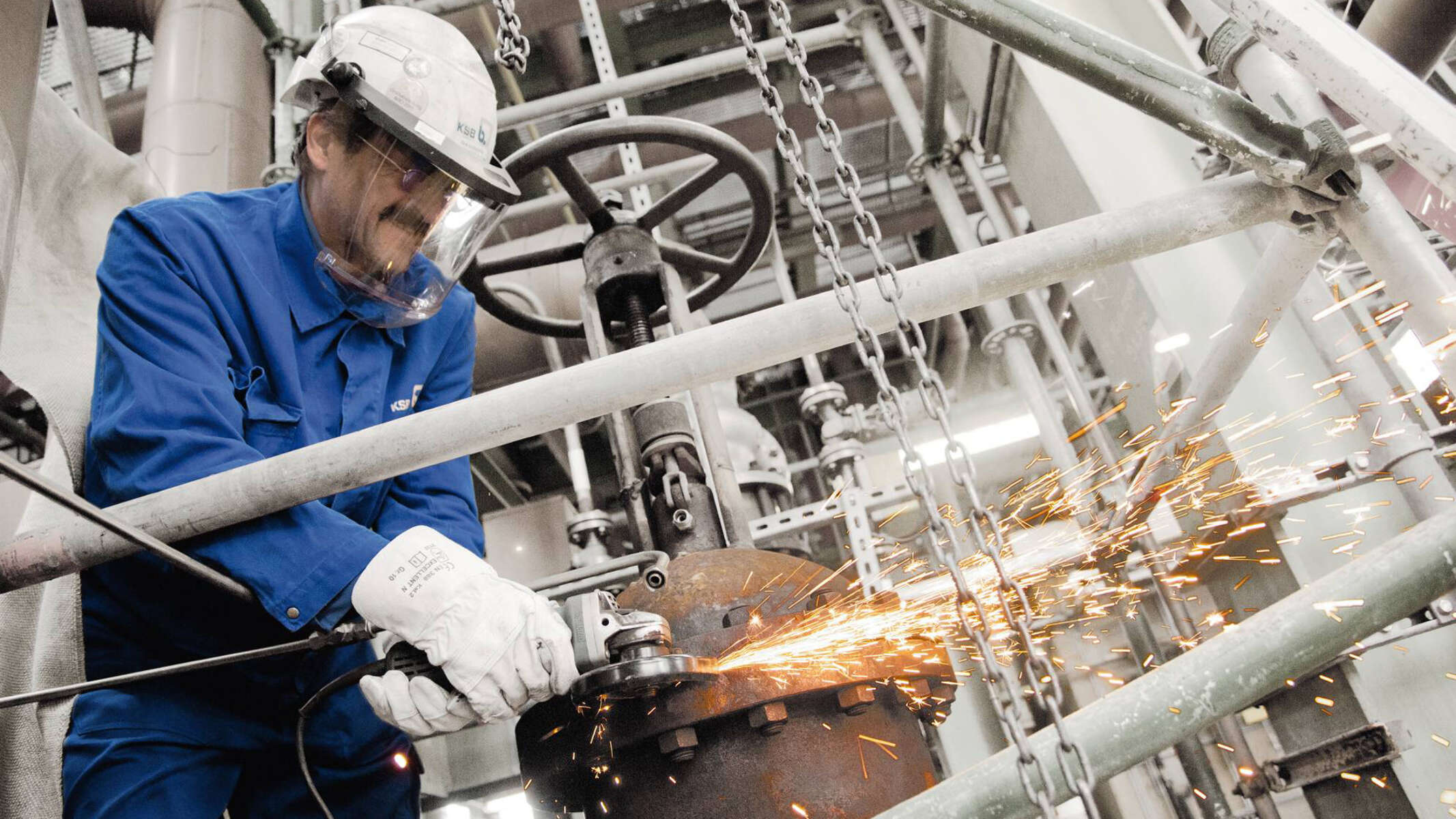 Technician welding a valve