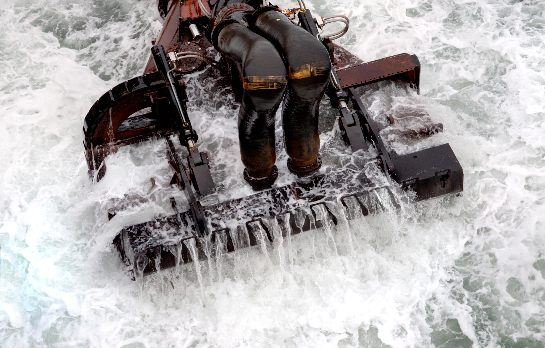 Dredging bucket in use in the ocean