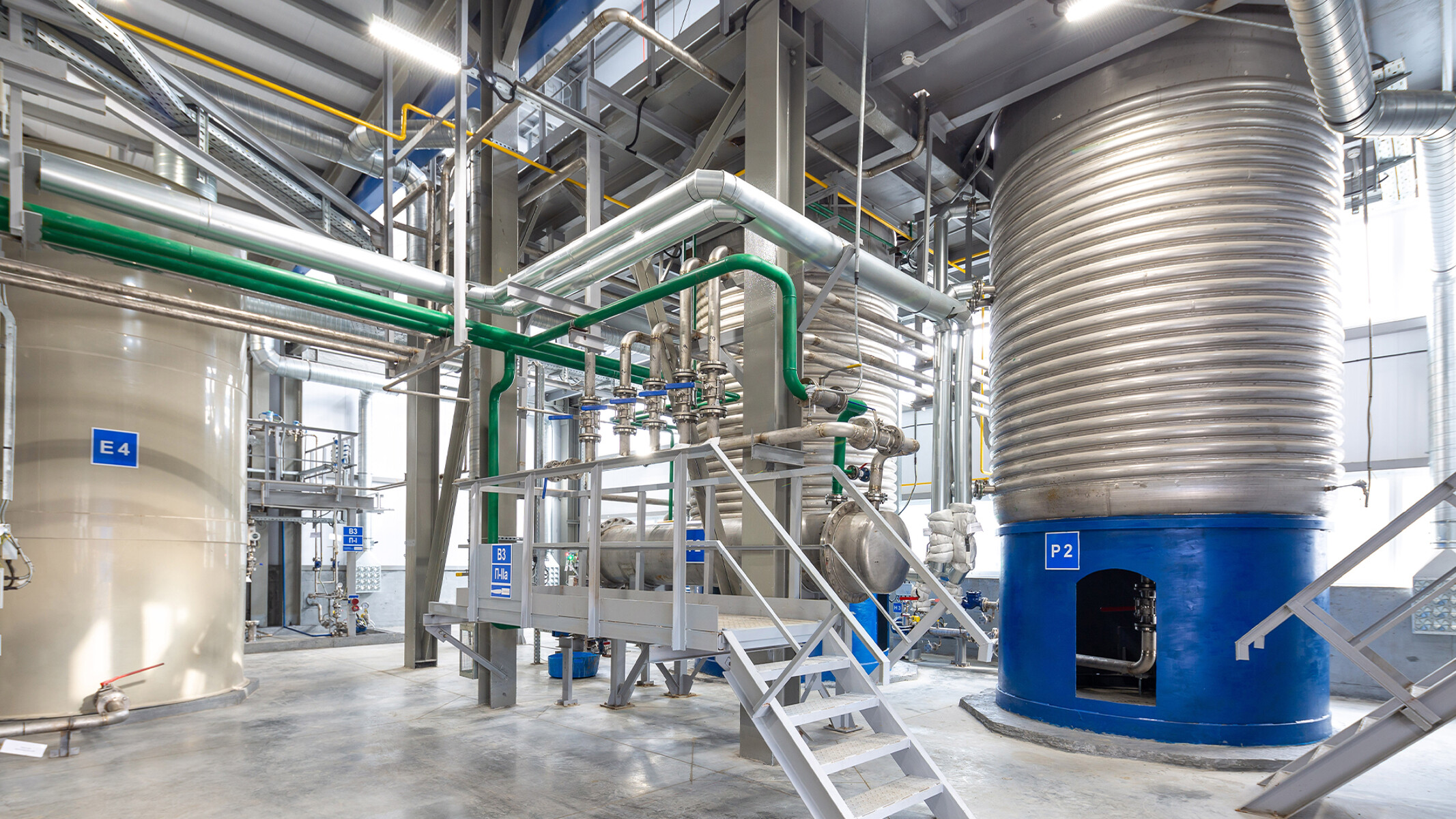 Large equipment and overhead piping inside a consumer chemicals factory