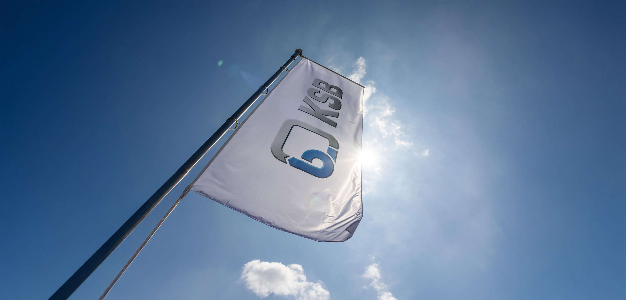 KSB flags in front of blue sky