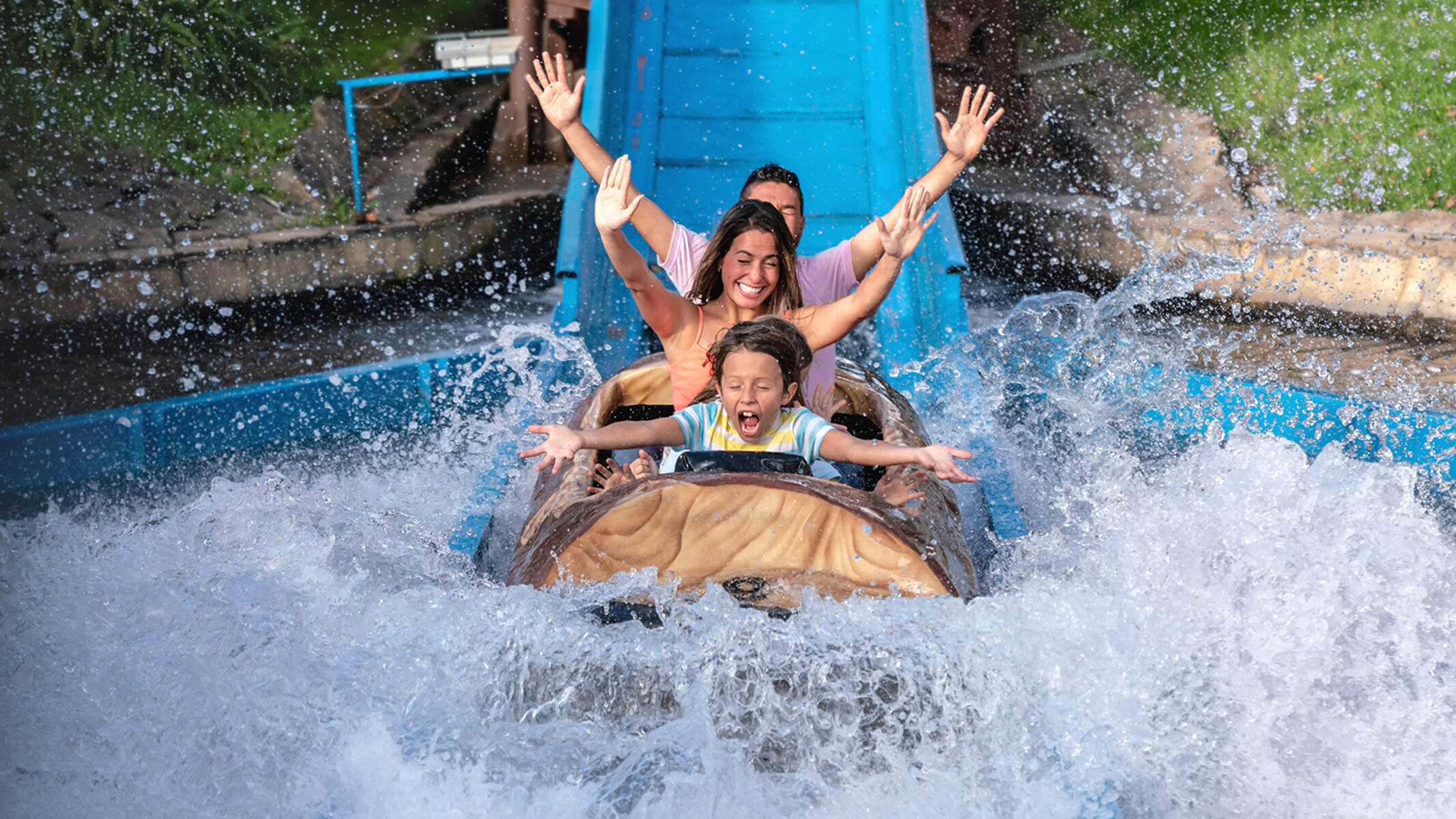 A family on a white water ride. The water splashes.