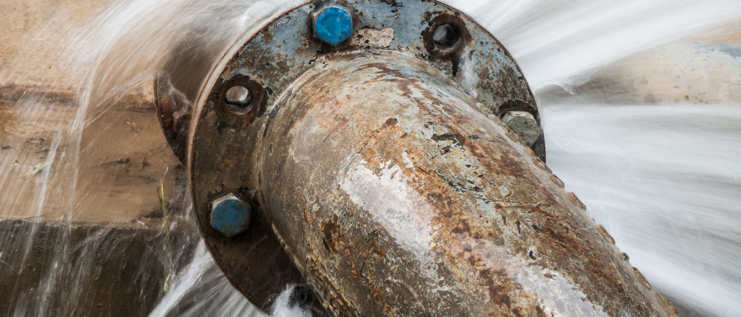 High-pressure water escaping from a leaking pipe