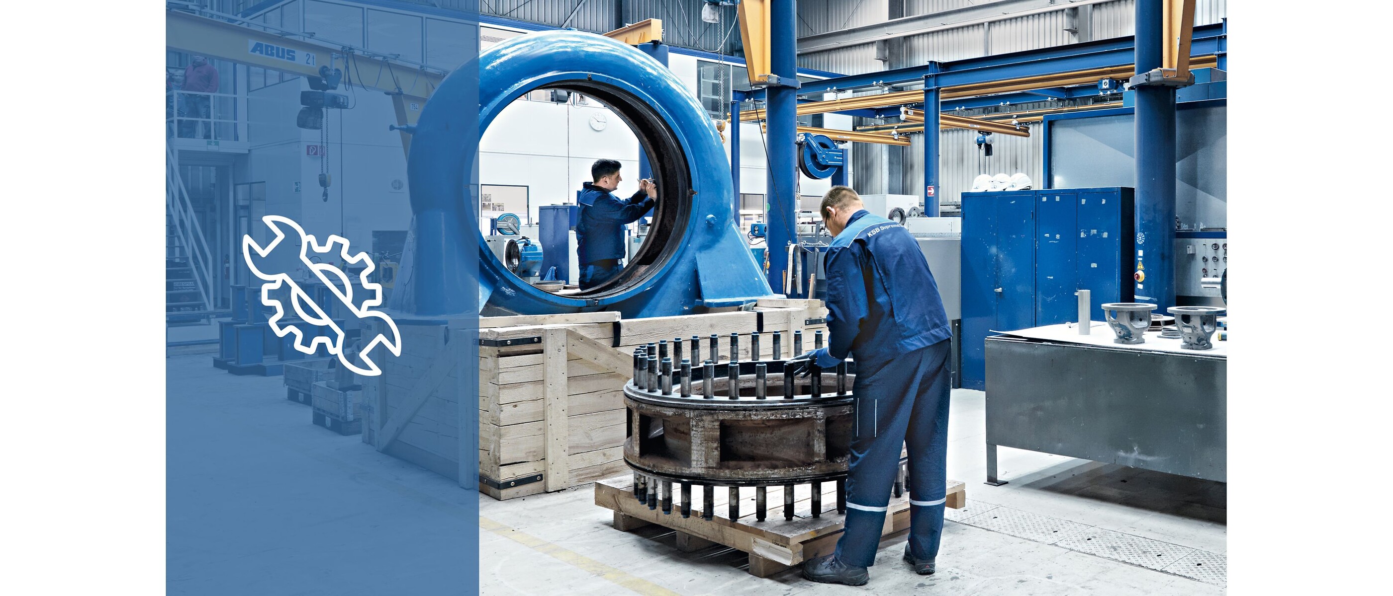 Two KSB service employees working on and repairing parts of a pump in a KSB service centre