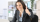 Female building services consultant working on laptop with thumbs up