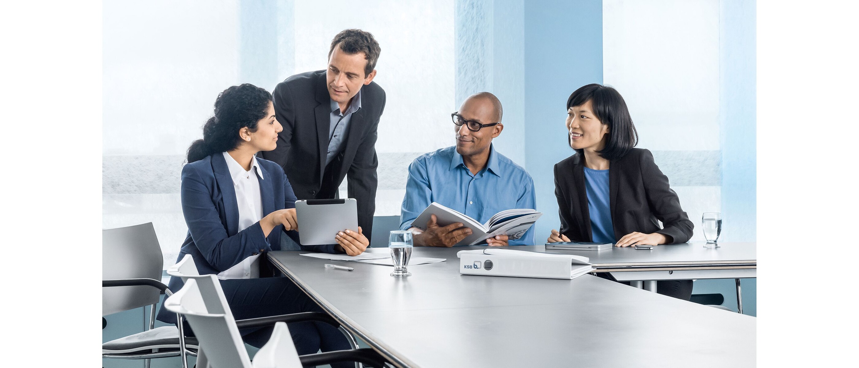Four colleagues having a discussion in the office